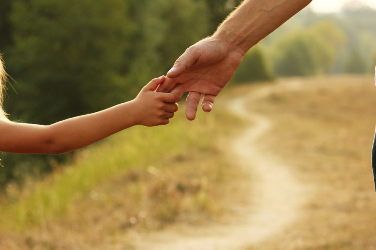 How to Prepare Your Children for Divorce - parent holds the hand of a small child