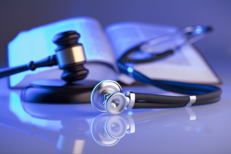 FAQs About Personal Injury Cases - medical book with gavel stethoscope